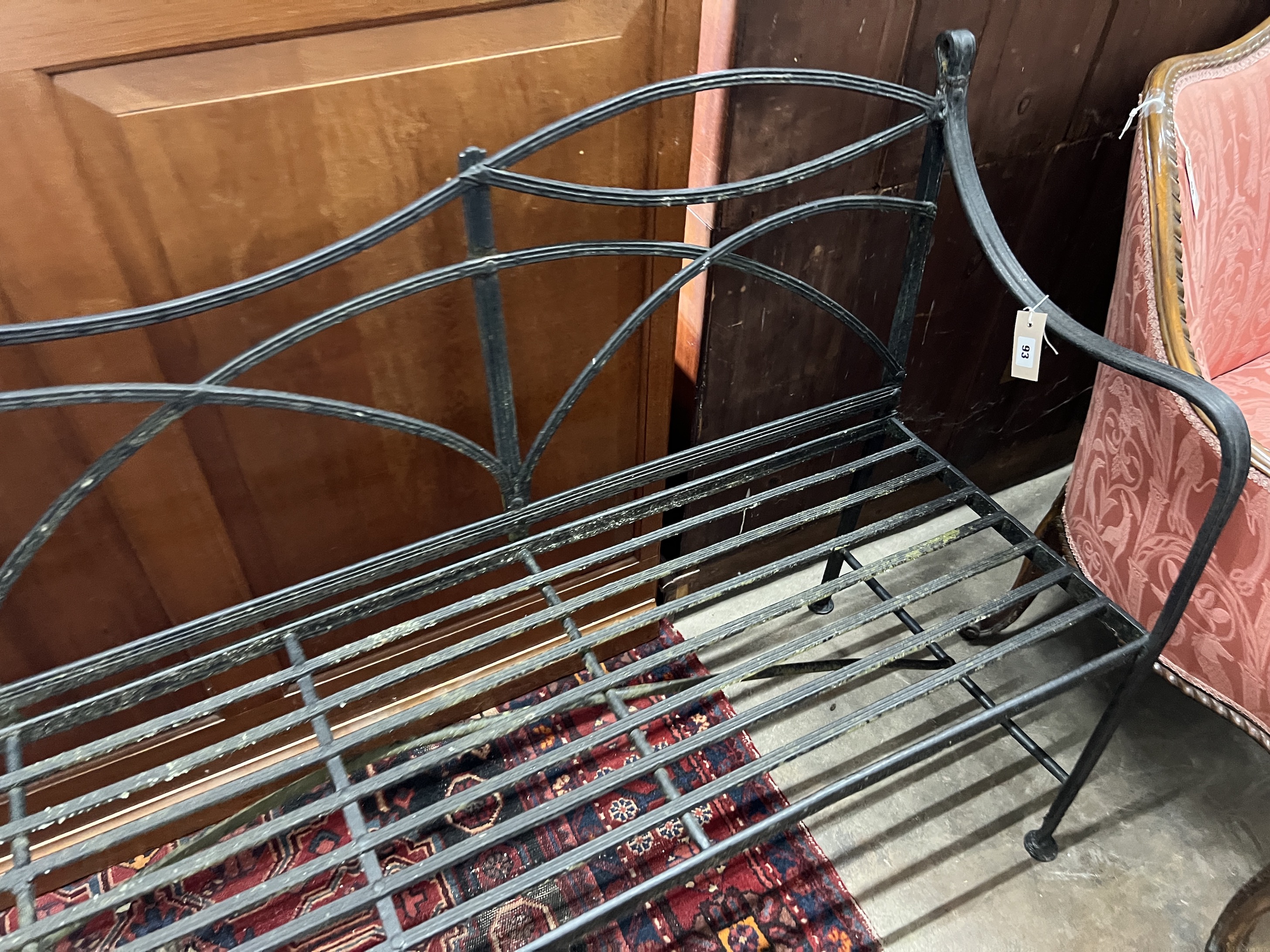 A painted wrought iron garden bench, length 166cm, depth 45cm, height 91cm